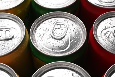 Photo of Energy drinks in wet cans, closeup. Functional beverage