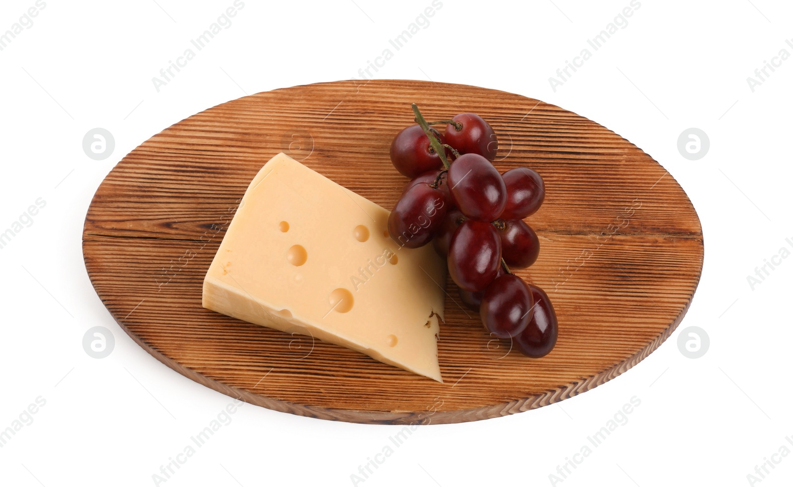 Photo of Piece of delicious cheese and grapes isolated on white, above view