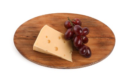 Photo of Piece of delicious cheese and grapes isolated on white, above view