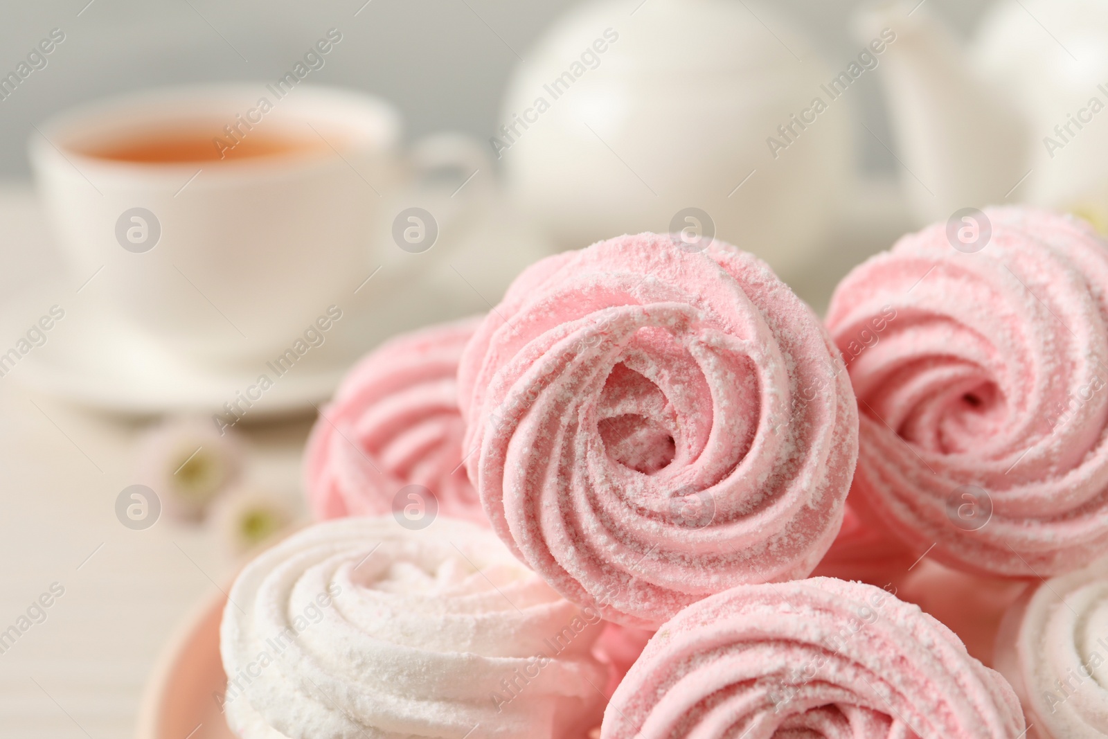 Photo of Delicious pink and white marshmallows on table, closeup