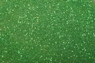 Beautiful shiny green glitter as background, closeup