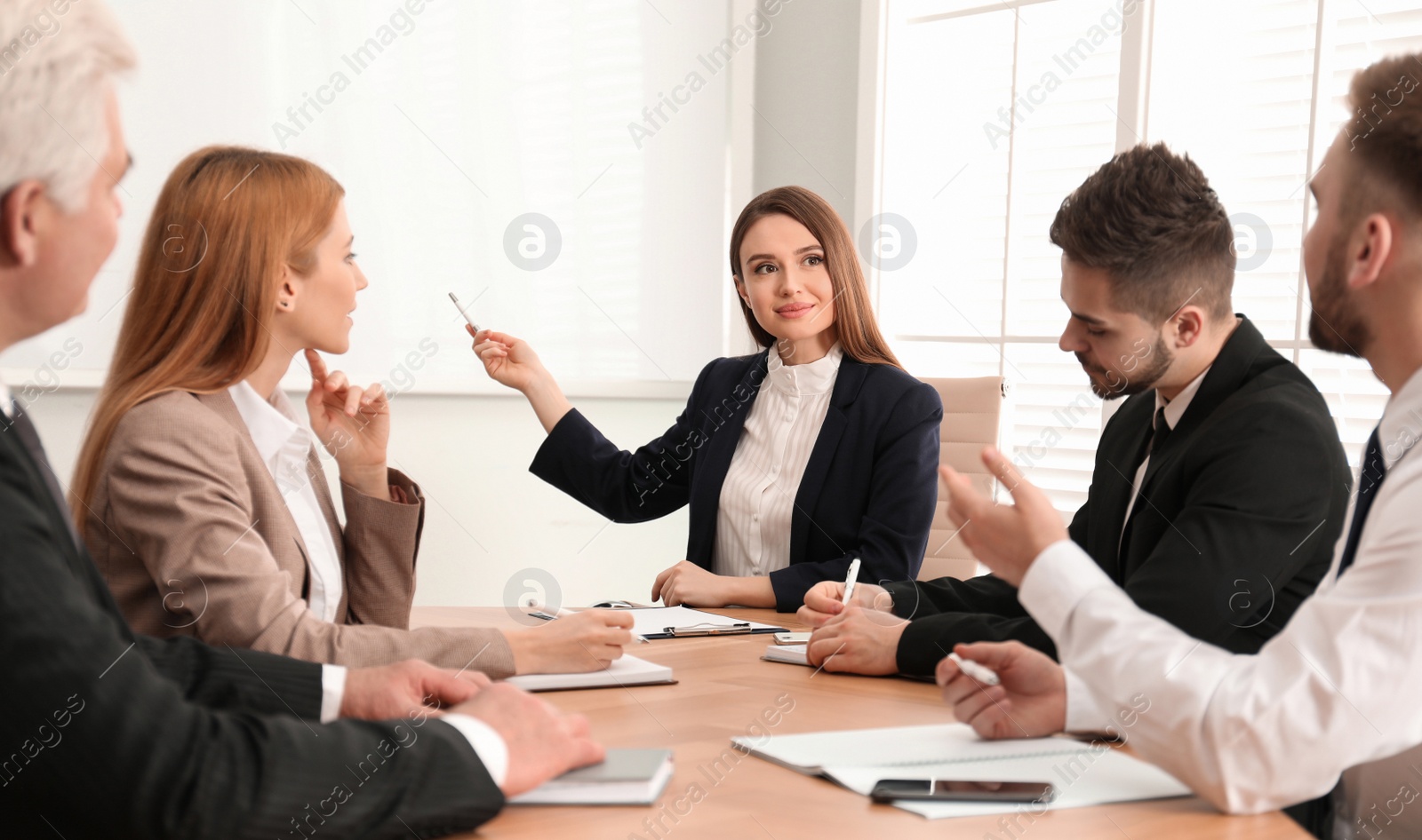 Photo of Professional business trainer working with people in office