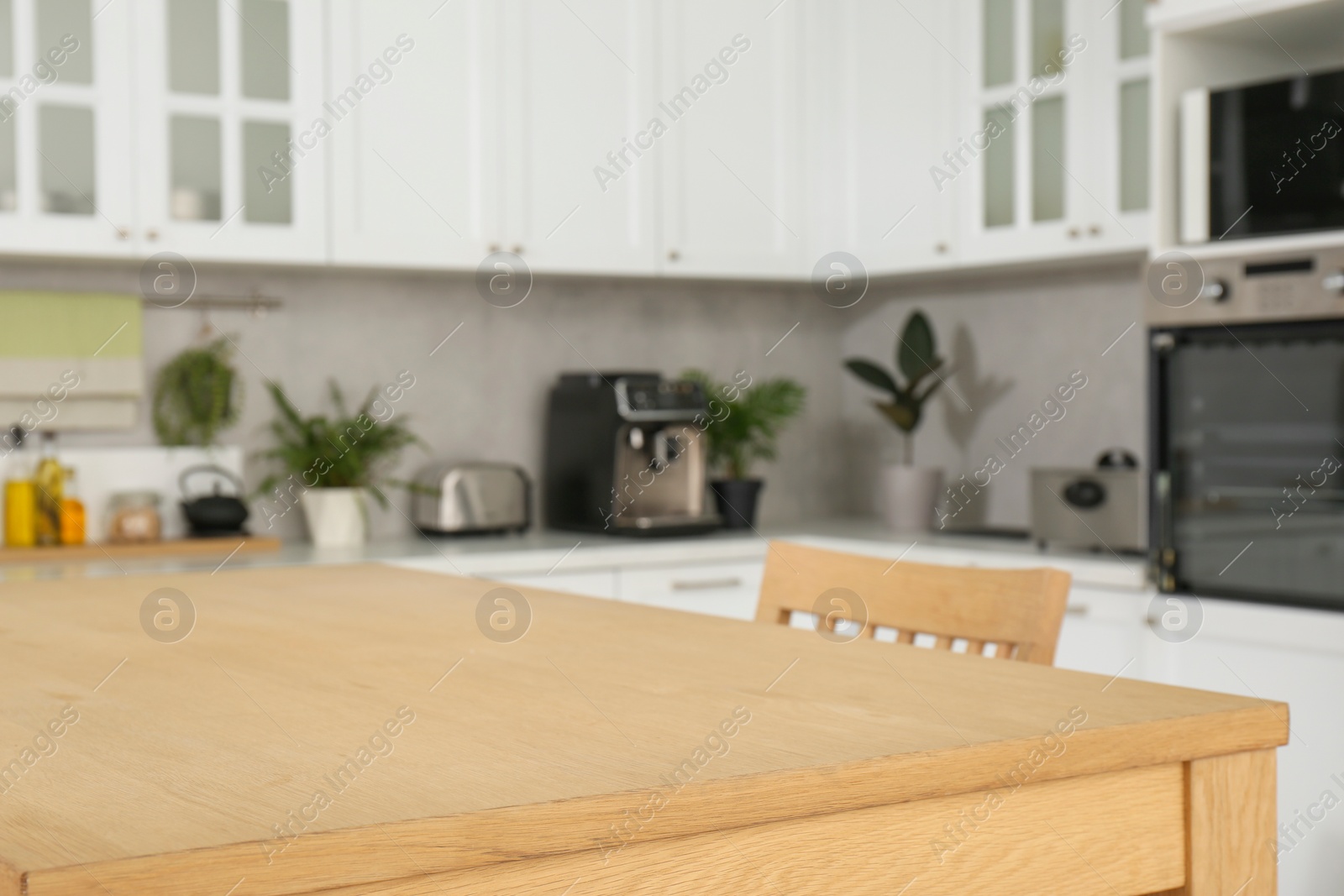 Photo of Stylish wooden table with chairs in kitchen. Interior design