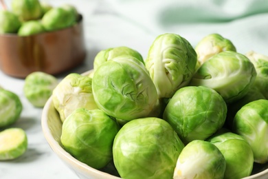 Bowl with fresh Brussels sprouts on table, closeup