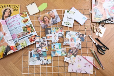 Photo of Flat lay composition with different photos, magazines, stationery and metal grid on wooden background. Creating vision board