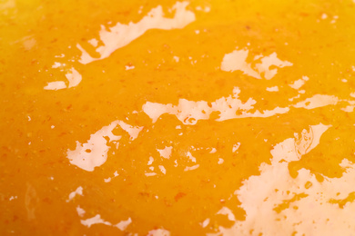 Sweet apricot jam as background, closeup view
