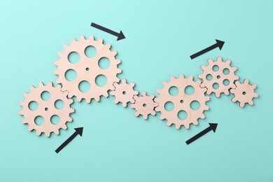 Business process organization and optimization. Scheme with wooden figures and arrows on light blue background, top view