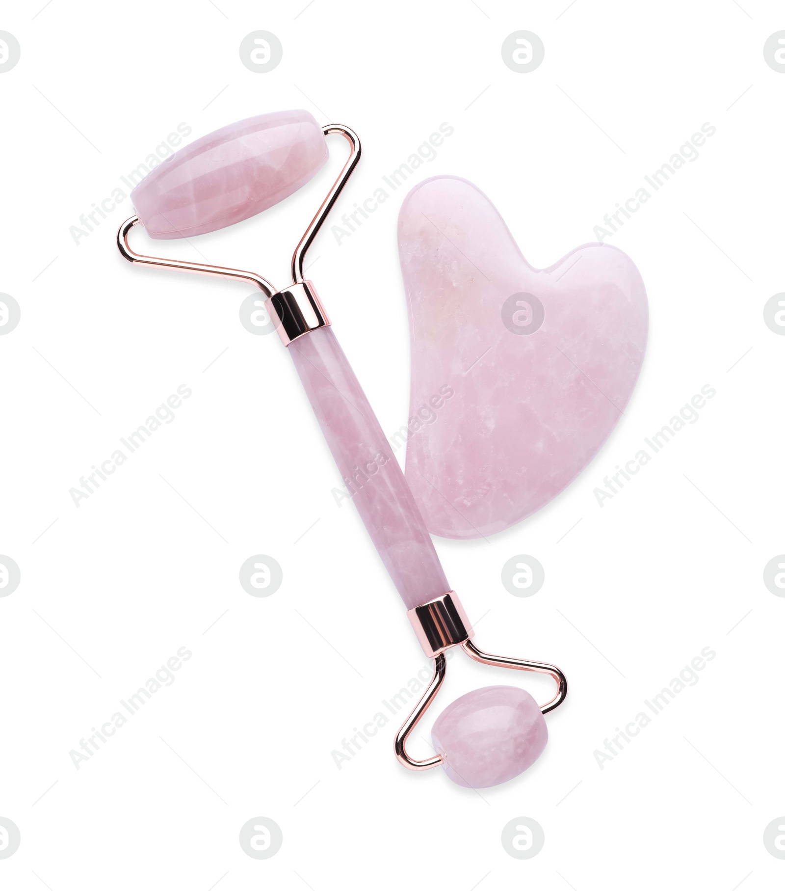 Photo of Rose quartz gua sha tool and facial roller isolated on white, top view