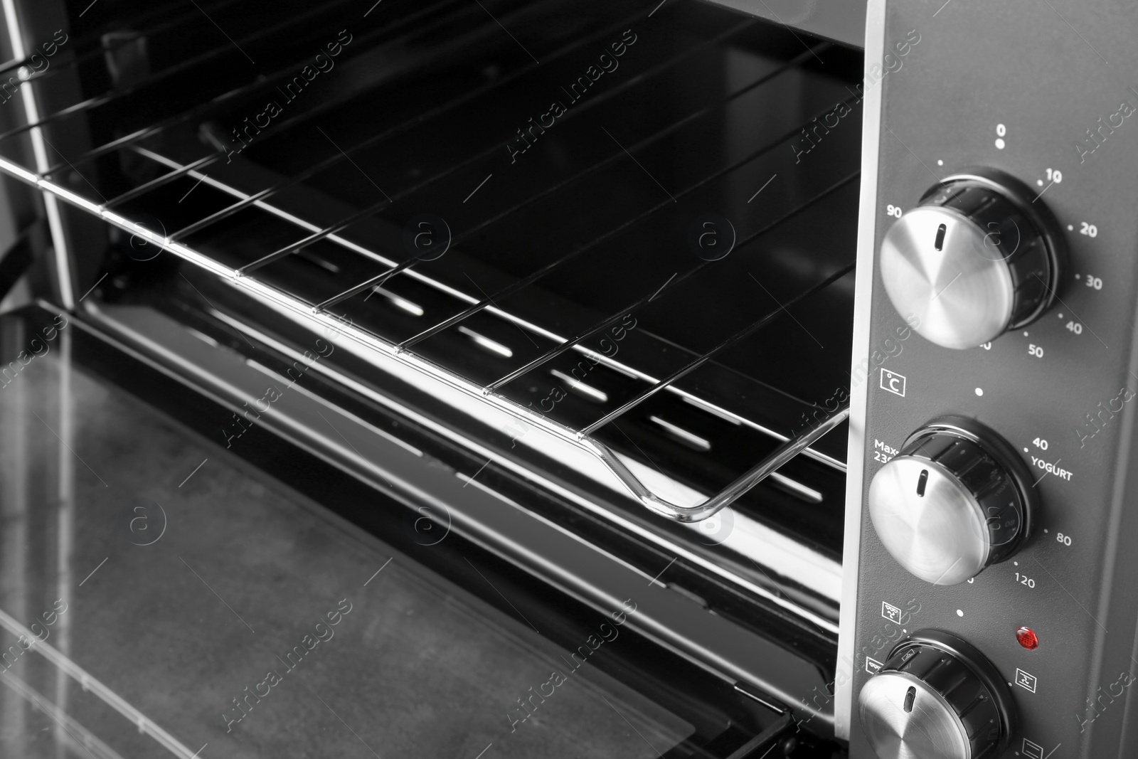 Photo of Open electric oven, closeup view. Cooking appliance