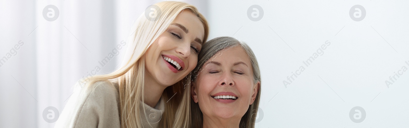 Image of Happy mother and daughter indoors, banner design