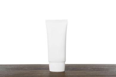 Photo of Tube of hand cream on wooden table against white background