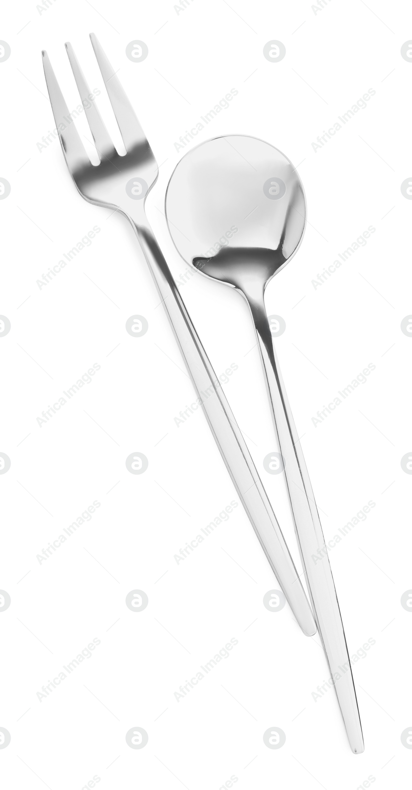 Photo of Spoon and fork isolated on white, top view. Stylish shiny cutlery set