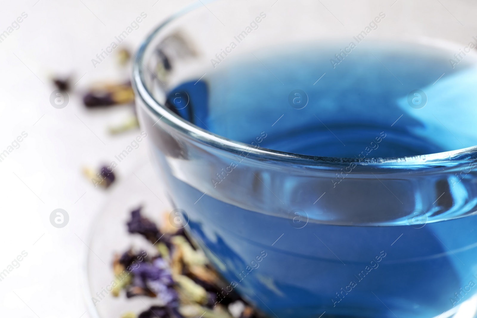 Photo of Glass cup of organic blue Anchan, closeup. Herbal tea