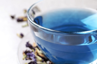 Photo of Glass cup of organic blue Anchan, closeup. Herbal tea