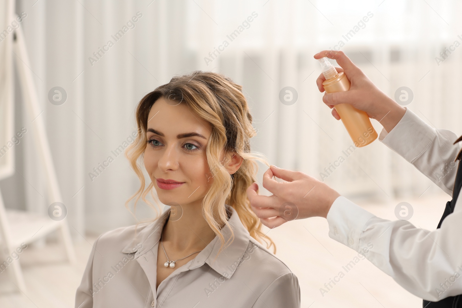 Photo of Hair styling. Professional hairdresser working with client indoors, closeup