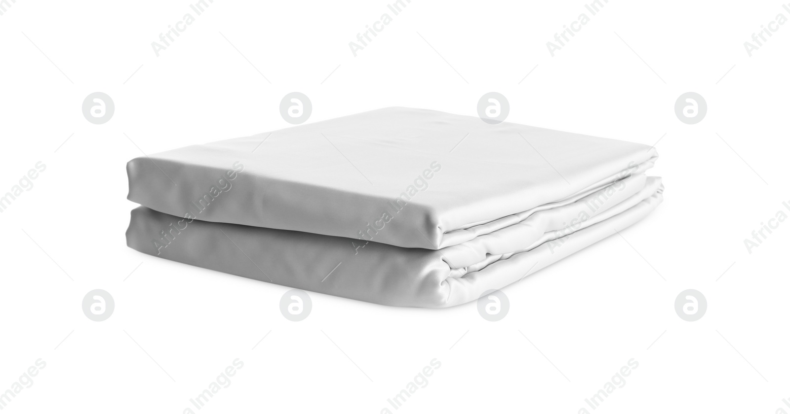 Photo of Stack of clean silky bed linen isolated on white