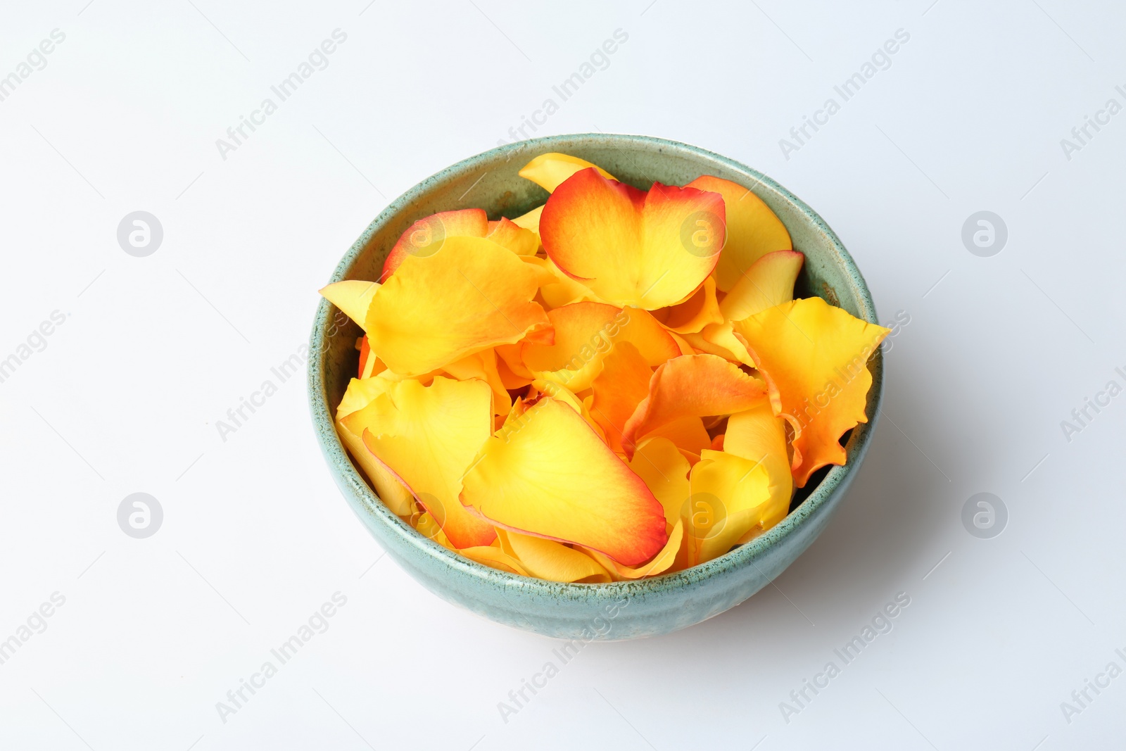 Photo of Bowl with rose petals on white background