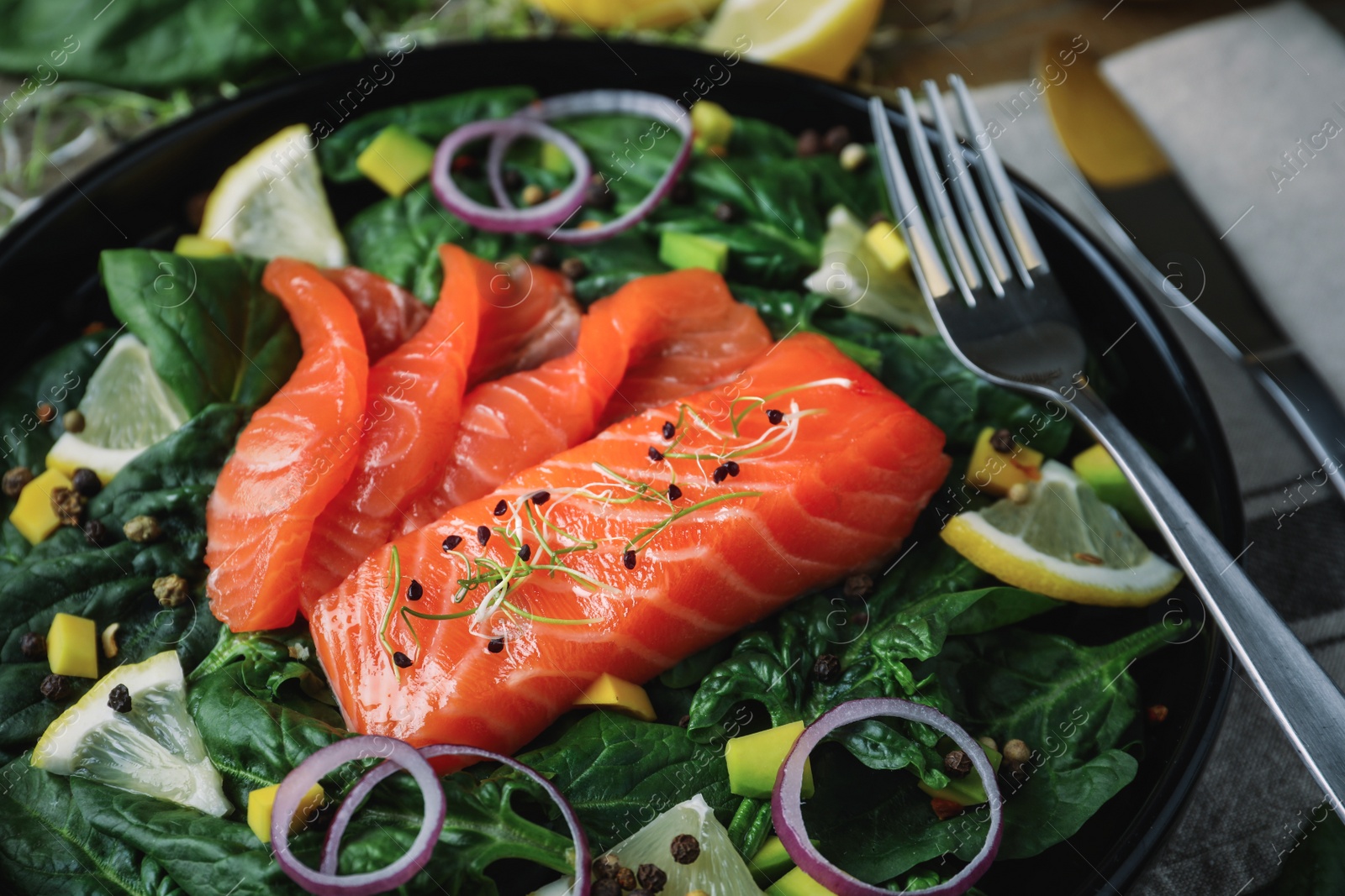 Image of Delicious fresh salmon with spinach on plate, closeup. Food photography  