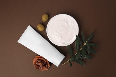 Photo of Flat lay composition with cosmetic products and olives on brown background