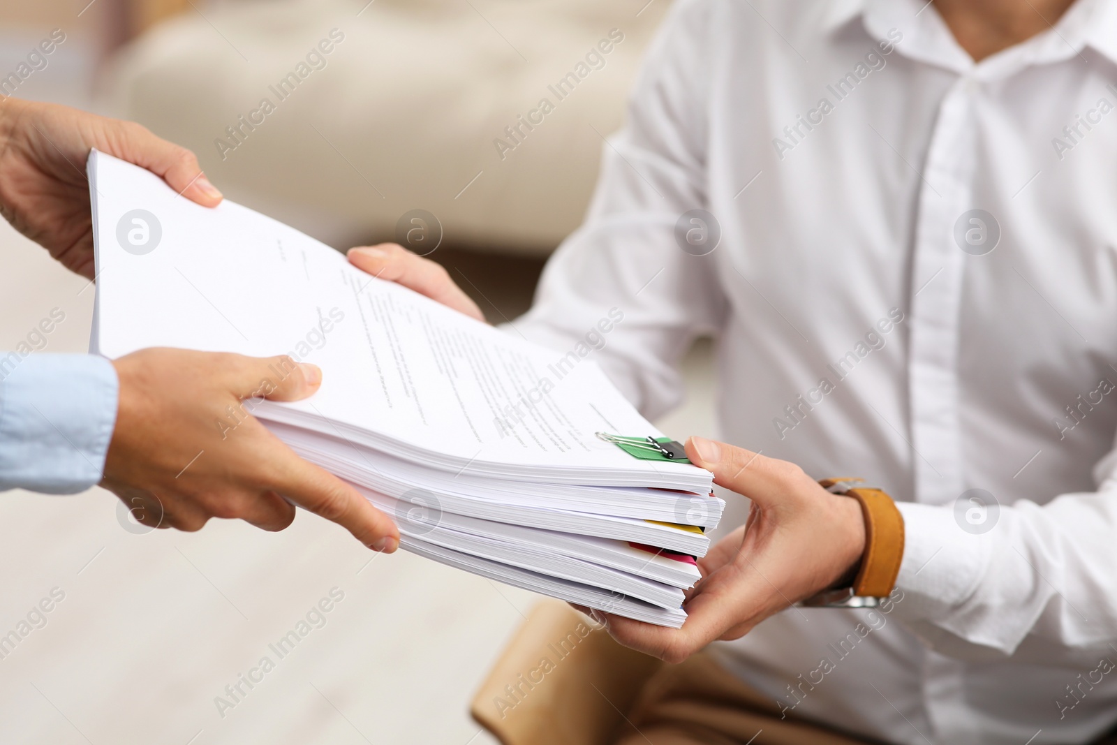 Photo of Woman giving documents to colleague in office, closeup