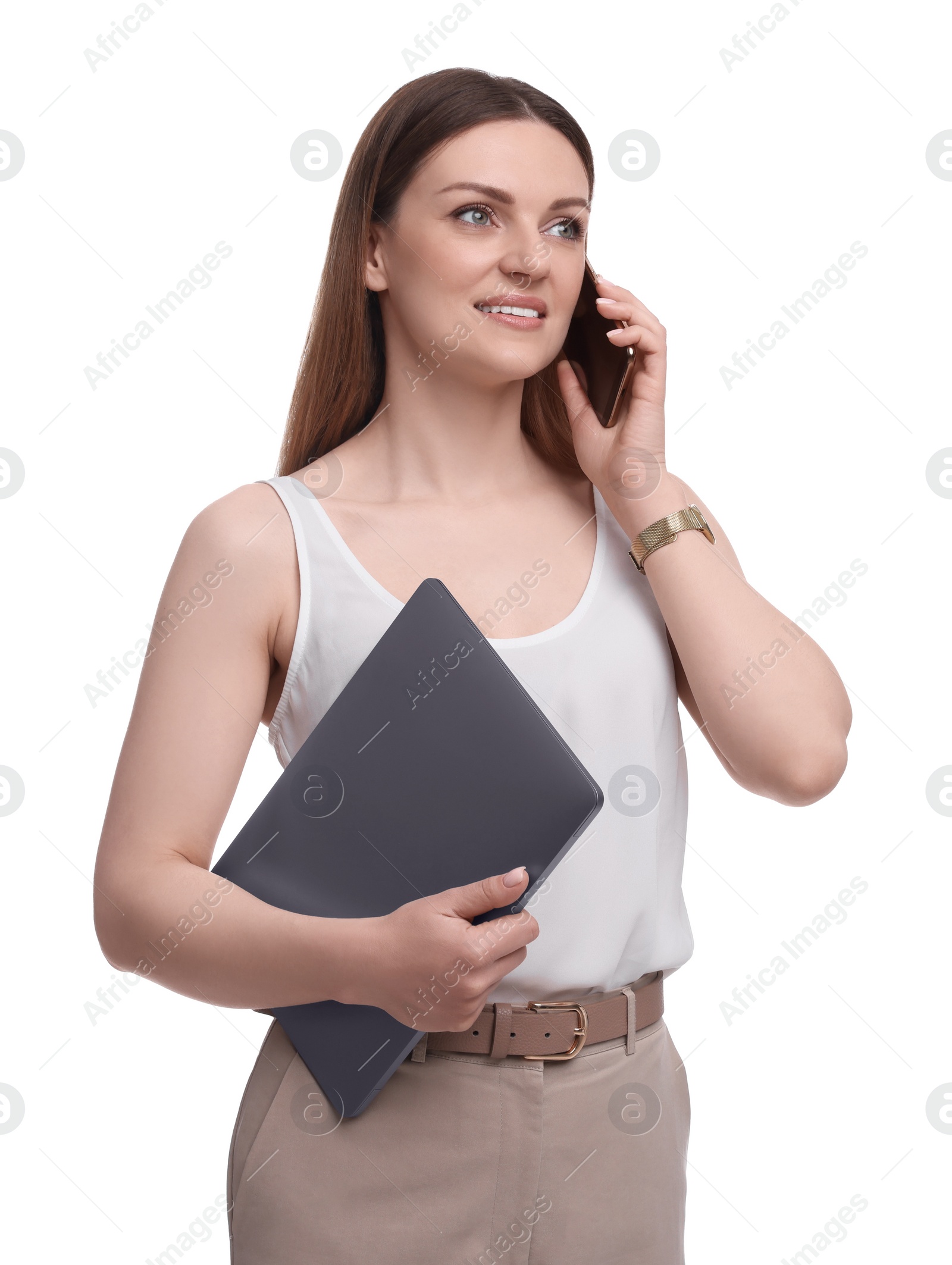 Photo of Beautiful businesswoman with laptop talking on smartphone against white background