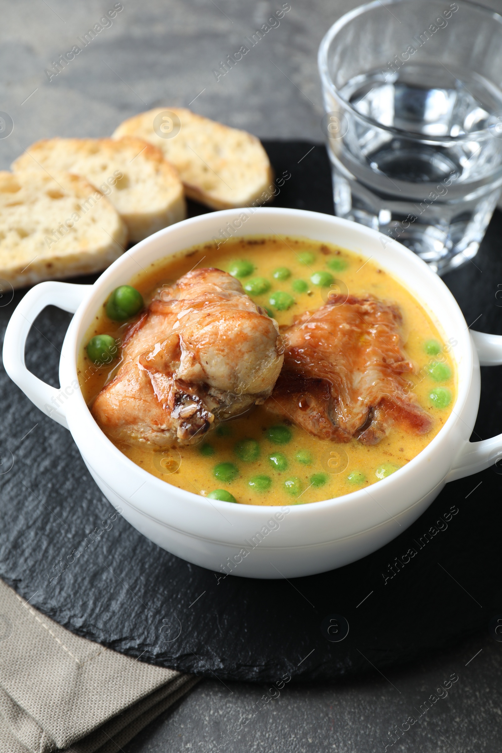 Photo of Tasty cooked rabbit meat with sauce served on table, closeup