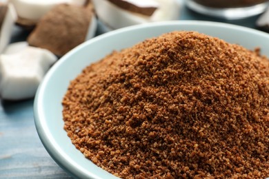 Natural coconut sugar in ceramic bowl, closeup