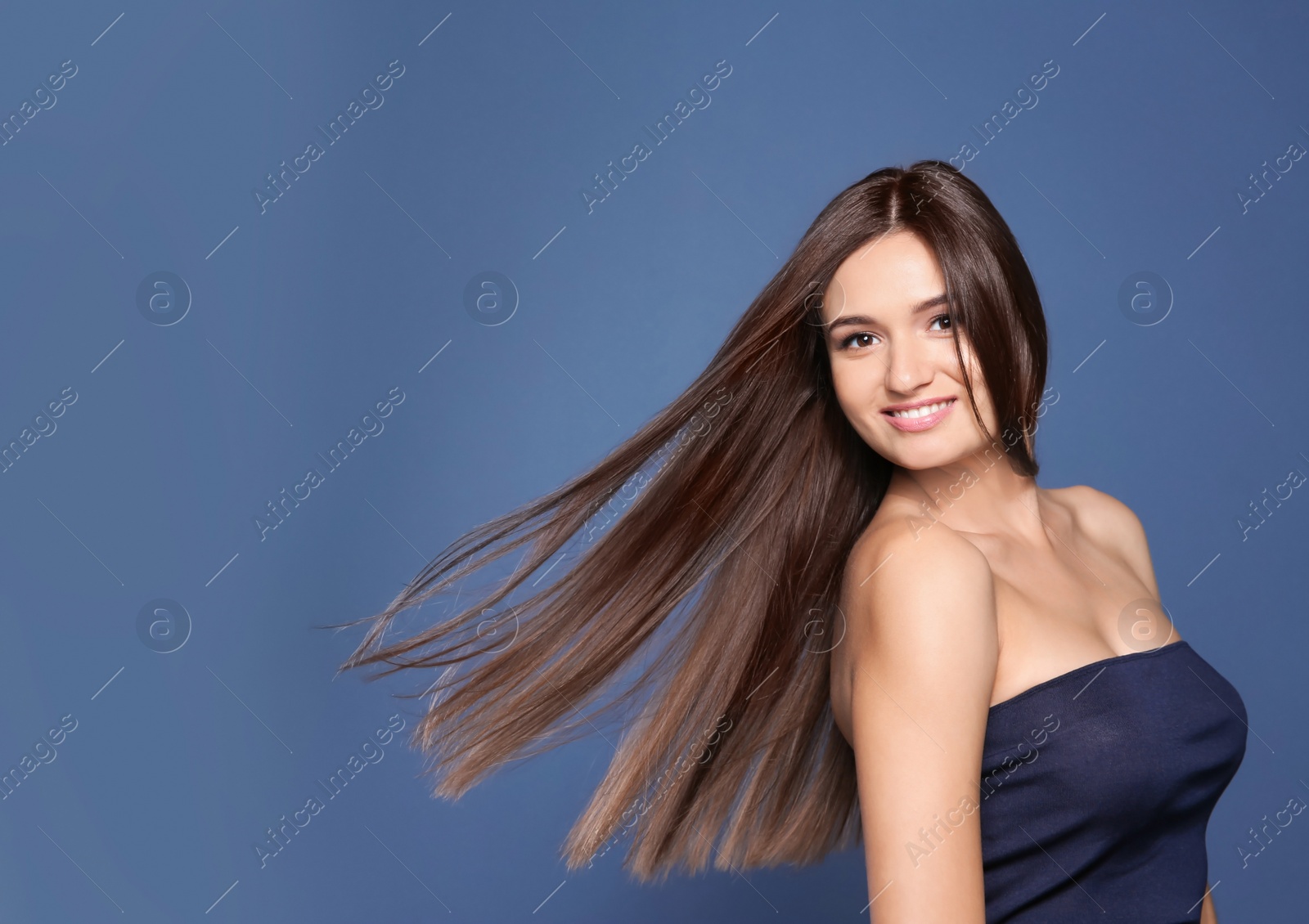 Photo of Portrait of beautiful model with gorgeous straight hair on color background