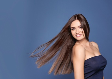 Photo of Portrait of beautiful model with gorgeous straight hair on color background