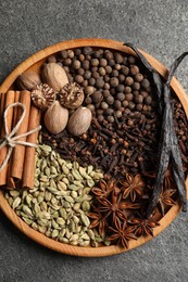 Photo of Different spices and nuts on gray table, top view