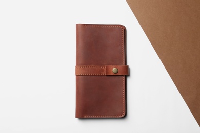 Stylish wallet on color background, top view