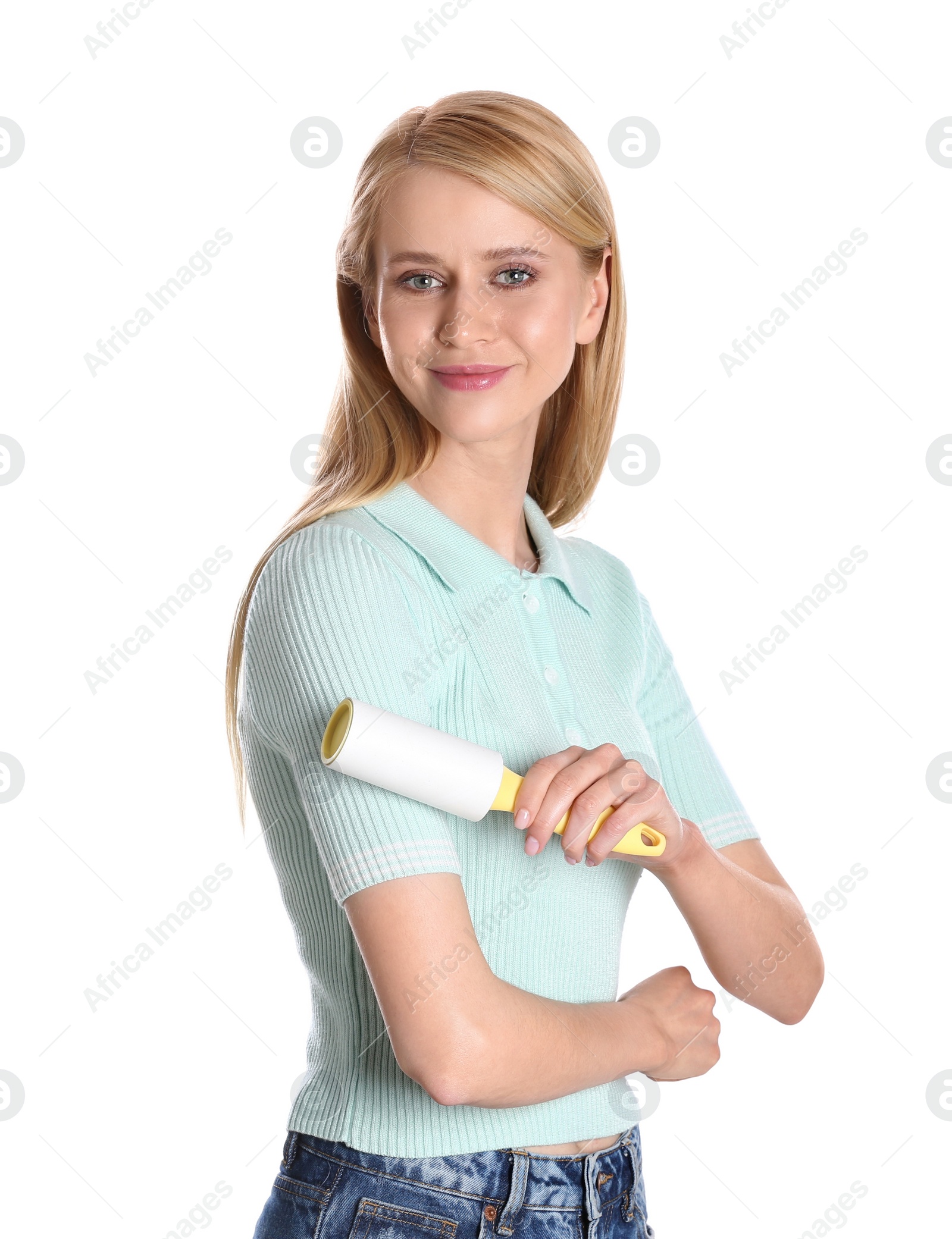 Photo of Young woman cleaning clothes with lint roller on white background