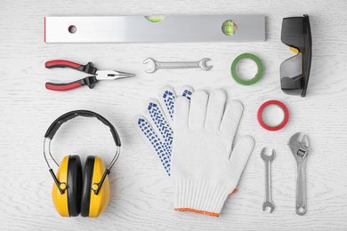 Photo of Flat lay composition with construction tools on white wooden background