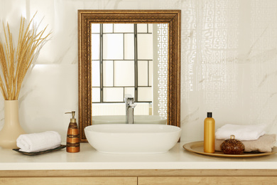 Photo of Vintage mirror and vessel sink in stylish bathroom