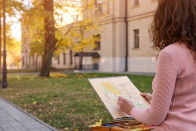 Woman drawing with soft pastels on street