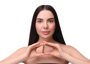 Photo of Beautiful young woman holding skincare ampoule on white background