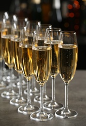 Photo of Glasses of champagne on table against blurred background