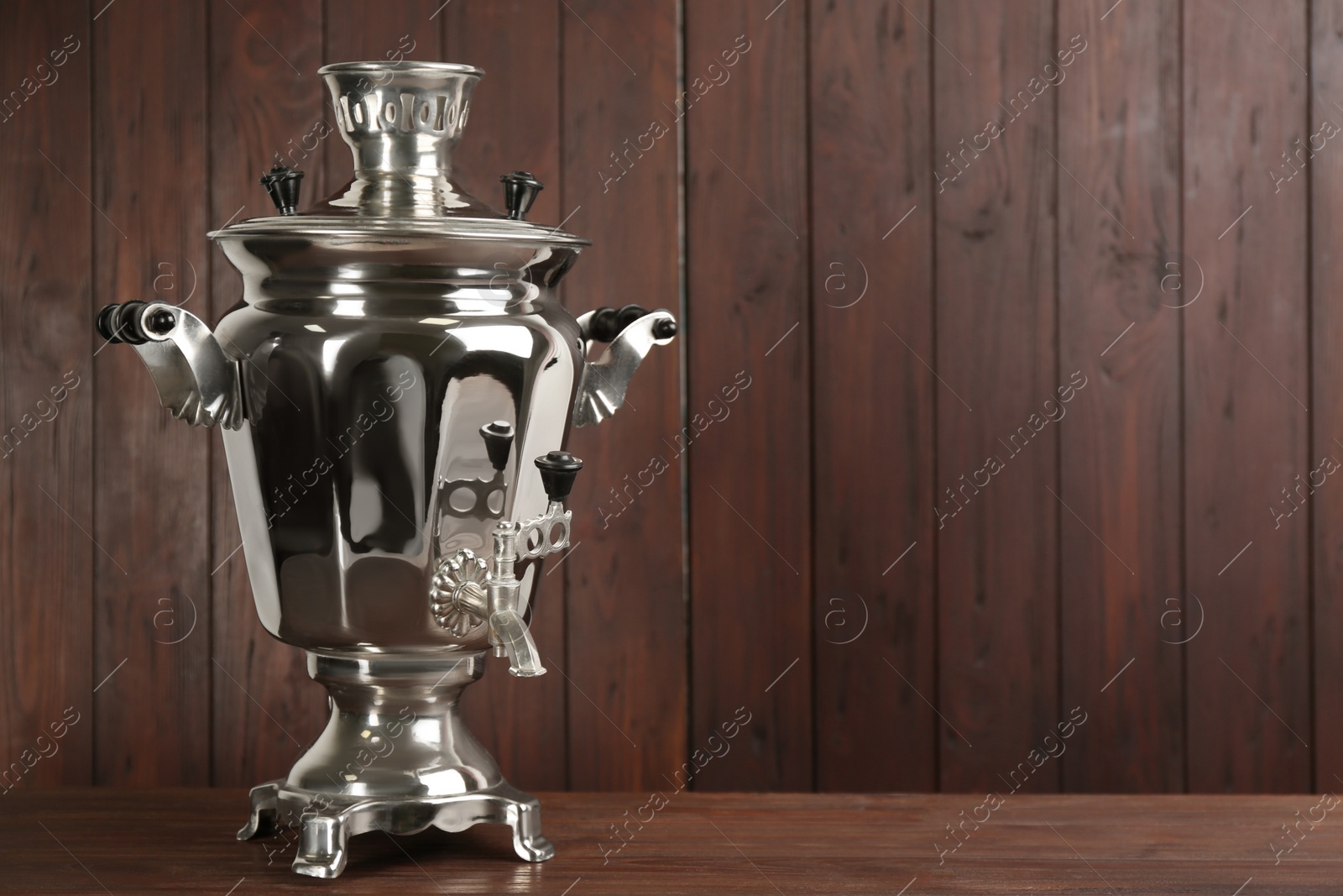 Photo of Traditional Russian samovar on wooden background. Space for text