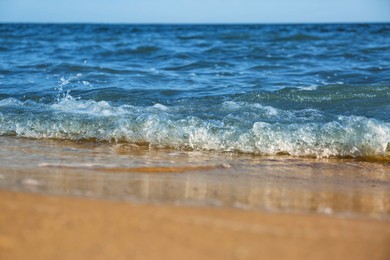 Photo of Beautiful view of sea waves on beach, closeup