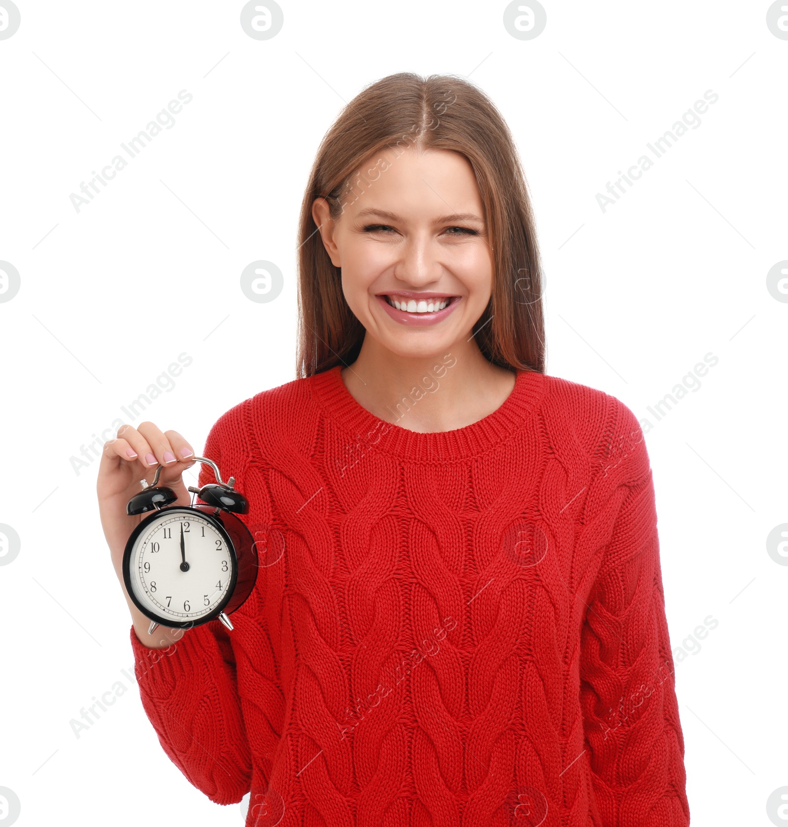 Photo of Happy young woman with alarm clock on white background. Christmas time