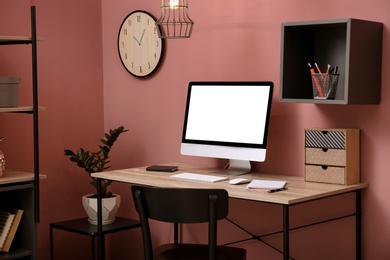 Comfortable workplace with computer on desk in home office