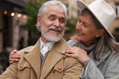 Portrait of affectionate senior couple walking outdoors