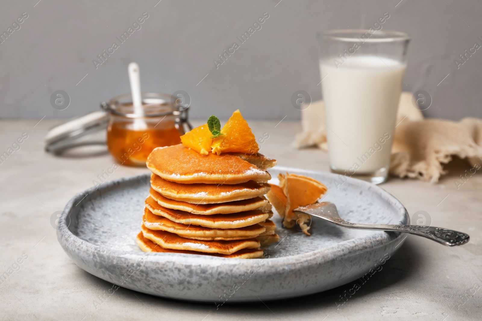 Photo of Tasty pancakes with orange on table