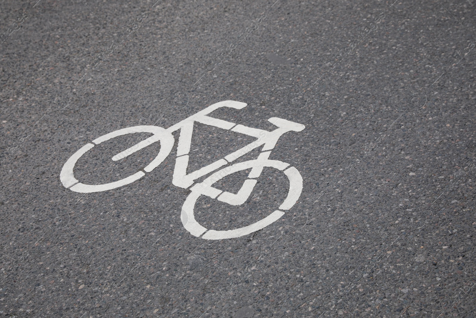 Photo of Bicycle lane with white sign painted on asphalt