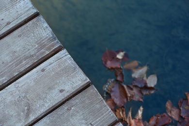 Photo of Wooden pier near pond. Space for text