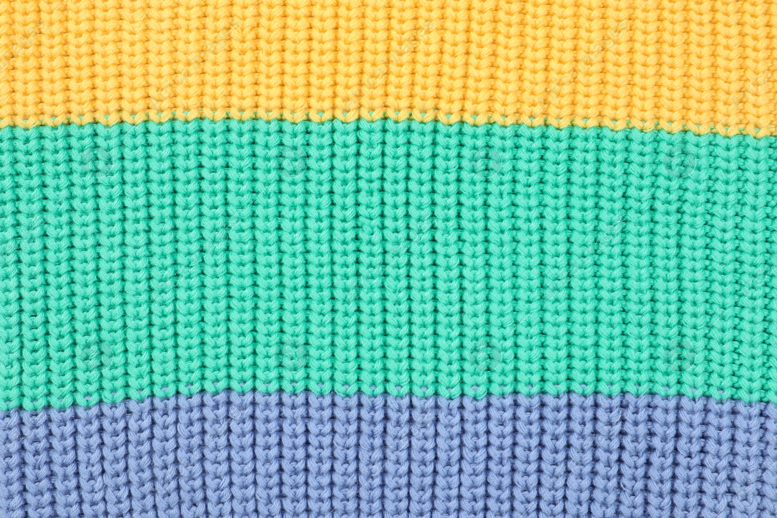 Photo of Texture of cozy warm sweater as background, closeup