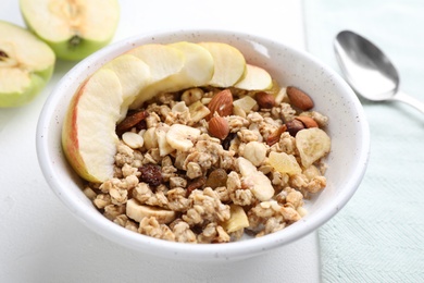 Photo of Muesli and apples on white wooden table. Healthy breakfast