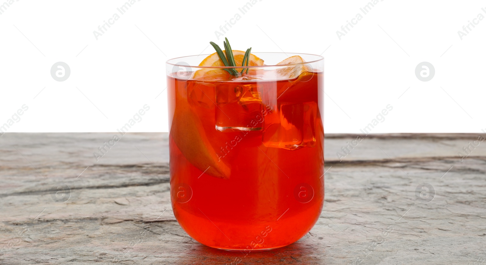 Photo of Aperol spritz cocktail, orange slices and rosemary in glass on grey textured table against white background