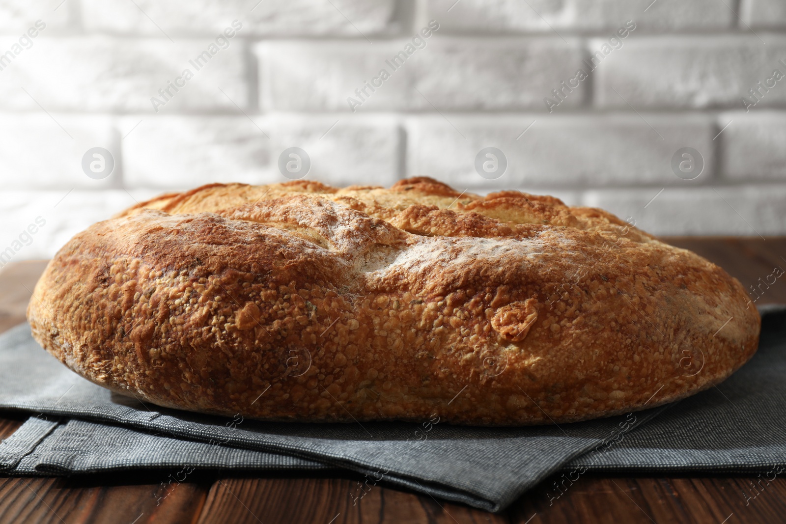 Photo of Freshly baked sourdough bread on wooden table