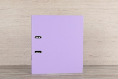 Lilac hardcover office folder on white wooden table
